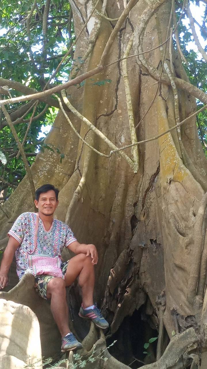 Rafael by an ancient jungle tree near the retreat venue