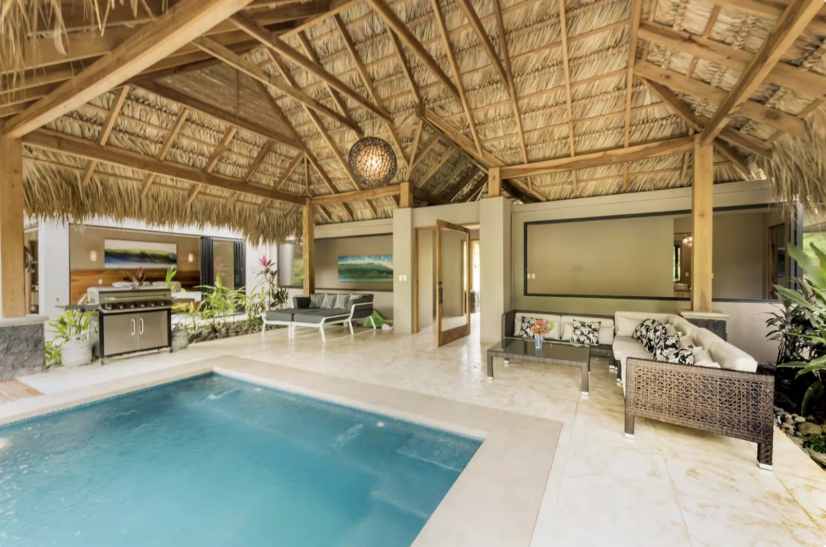 Indoor pool under a traditional Balinese thatched roof