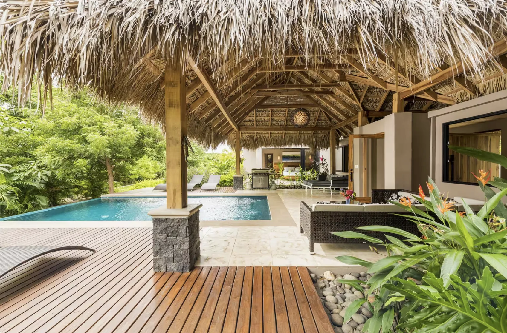Luxury Bali villa pool with traditional alang-alang roof